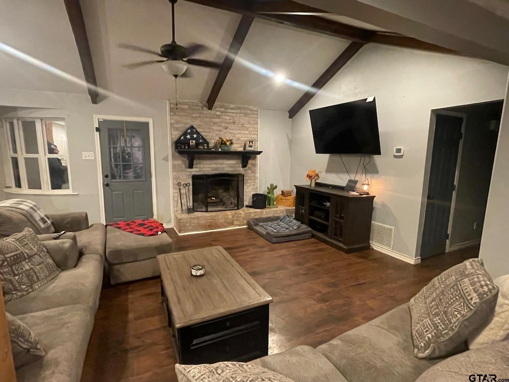 living room featuring a fireplace, lofted ceiling with beams, dark hardwood / wood-style floors, and ceiling fan