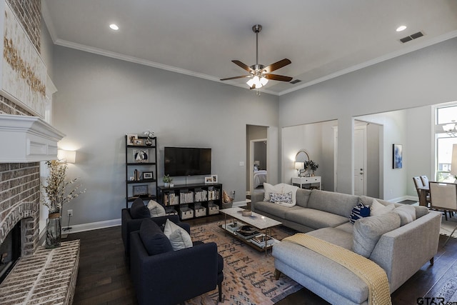 7317 Hearthstone Ln, Tyler, TX 75703 - living room featuring a brick fireplace, dark wood finished floors, ceiling fan, crown molding, and recessed lighting