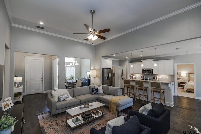 7317 Hearthstone Ln, Tyler, TX 75703 - living area featuring dark wood finished floors, crown molding, ceiling fan, a chandelier, and a towering ceiling