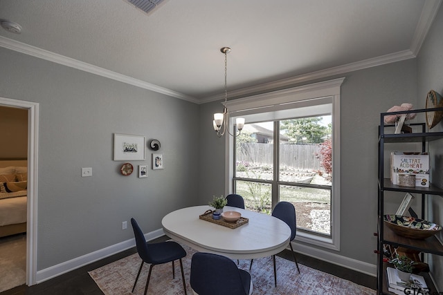 7317 Hearthstone Ln, Tyler, TX 75703 - dining space with crown molding, dark wood-style flooring, and a chandelier