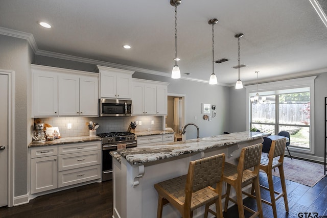 7317 Hearthstone Ln, Tyler, TX 75703 - kitchen featuring appliances with stainless steel finishes, crown molding, tasteful backsplash, dark wood-style floors, and light stone countertops