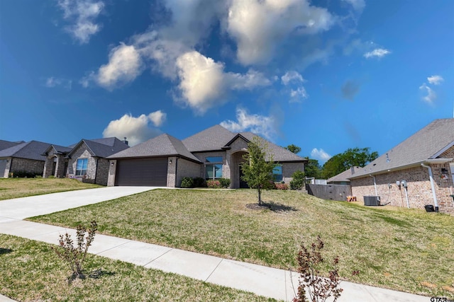 7317 Hearthstone Ln, Tyler, TX 75703 - view of front of home featuring an attached garage, driveway, brick siding, and a residential view