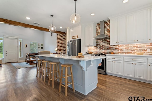 15988 C R 1151, Tyler, TX 75704 - kitchen featuring wall chimney range hood, stainless steel appliances, dark wood-style flooring, recessed lighting, and white cabinets