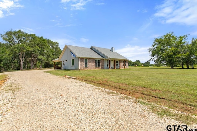 15988 C R 1151, Tyler, TX 75704 - single story home featuring a front yard, gravel driveway, brick siding, and a chimney