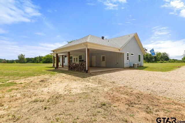 15988 C R 1151, Tyler, TX 75704 - view of side of home with driveway, board and batten siding, a yard, an attached carport, and a patio