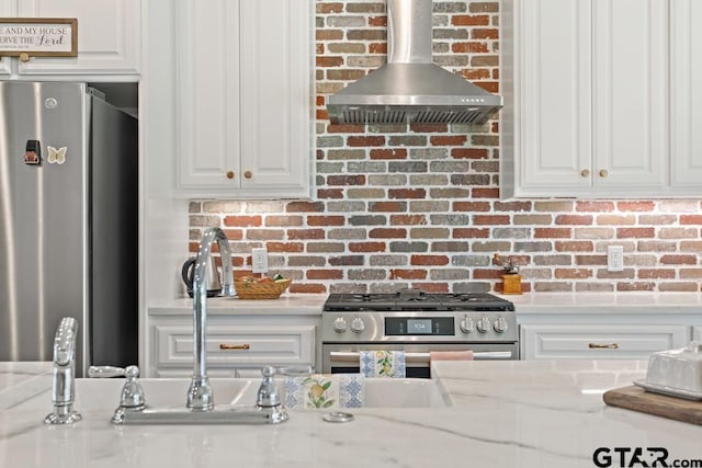 15988 C R 1151, Tyler, TX 75704 - kitchen with wall chimney exhaust hood, stainless steel appliances, white cabinetry, and decorative backsplash