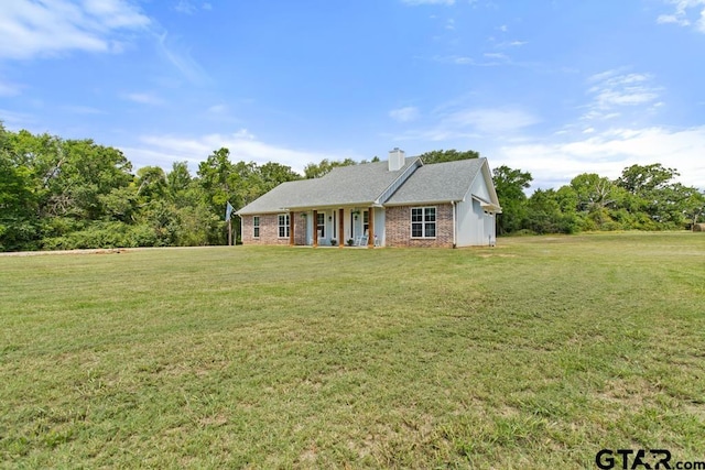 15988 C R 1151, Tyler, TX 75704 - ranch-style house with a front lawn, covered porch, brick siding, and a chimney