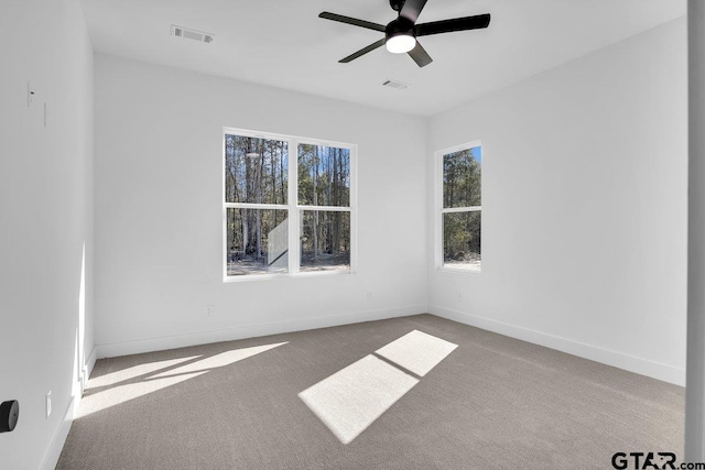 unfurnished room with light carpet and ceiling fan