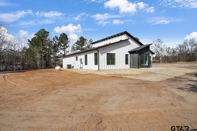 view of side of property with central AC