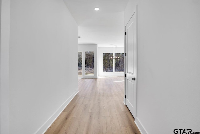 hall with light hardwood / wood-style flooring