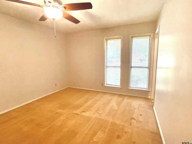609 Francis St, Hawkins, TX 75765 - spare room featuring baseboards, ceiling fan, and light carpet