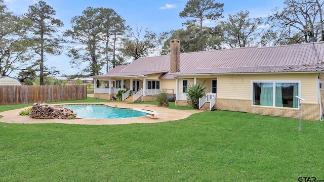 view of pool with a porch and a lawn