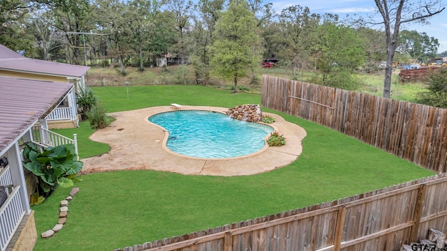 view of swimming pool with a patio, a lawn, and pool water feature