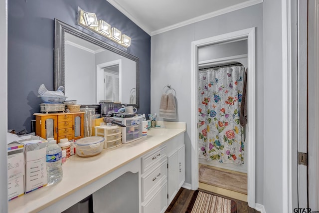 bathroom featuring hardwood / wood-style flooring, vanity, and ornamental molding