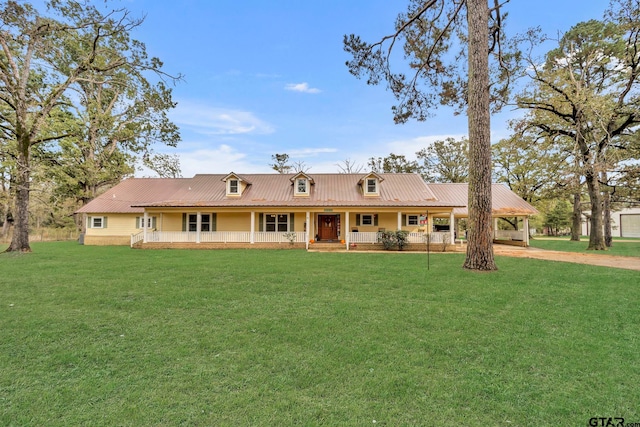 rear view of property featuring a lawn and covered porch