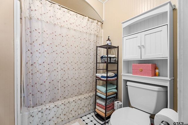 bathroom with a shower with curtain and toilet