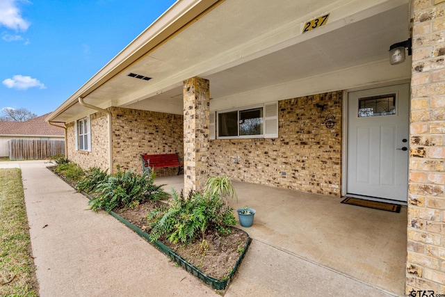 view of exterior entry featuring a patio