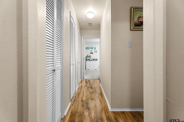 hall with hardwood / wood-style floors