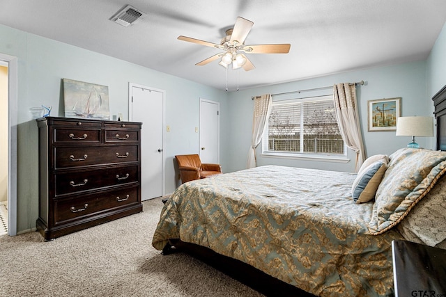 bedroom with ceiling fan and light carpet