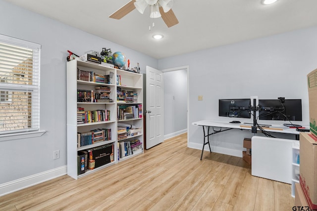 office with ceiling fan and light hardwood / wood-style flooring