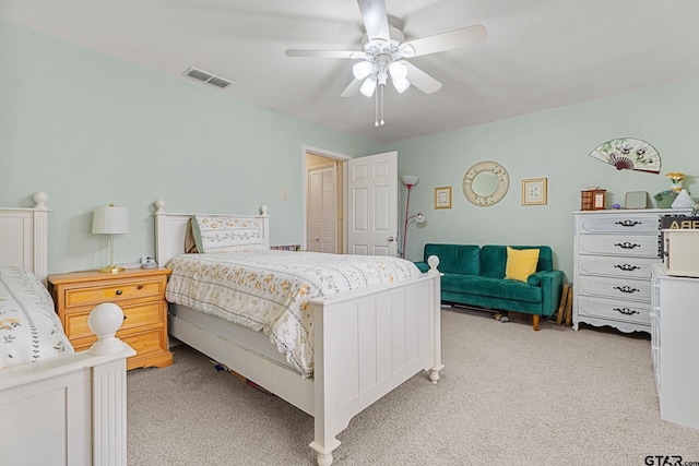 bedroom with ceiling fan and light carpet