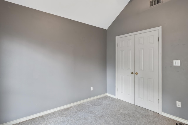 3110 Oleander Dr, Tyler, TX 75707 - unfurnished bedroom with a closet, carpet flooring, baseboards, visible vents, and lofted ceiling