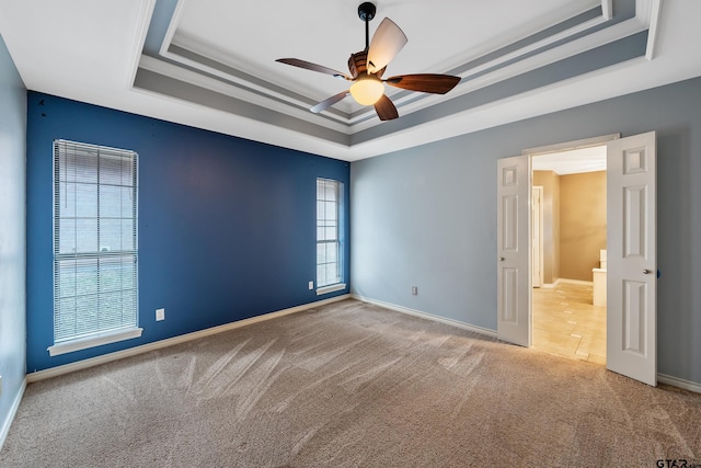 3110 Oleander Dr, Tyler, TX 75707 - carpeted empty room with baseboards, a raised ceiling, and a ceiling fan