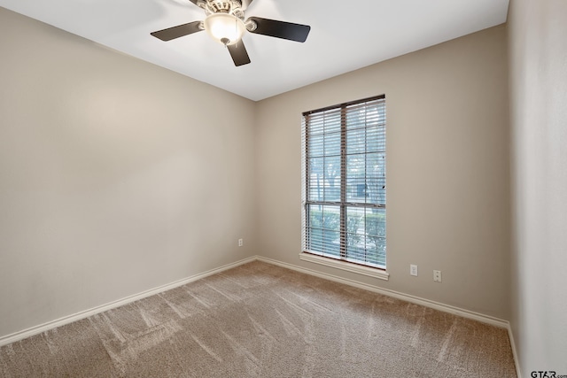 3110 Oleander Dr, Tyler, TX 75707 - carpeted spare room featuring baseboards, a ceiling fan, and a wealth of natural light