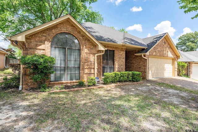 3110 Oleander Dr, Tyler, TX 75707 - ranch-style home with a front yard, a garage, brick siding, roof with shingles, and concrete driveway