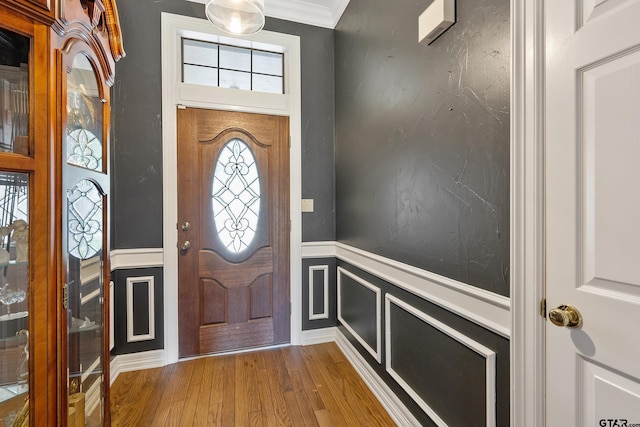 3110 Oleander Dr, Tyler, TX 75707 - foyer with ornamental molding, a decorative wall, wainscoting, and wood finished floors