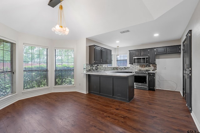 3110 Oleander Dr, Tyler, TX 75707 - kitchen with dark wood finished floors, appliances with stainless steel finishes, light countertops, visible vents, and a peninsula