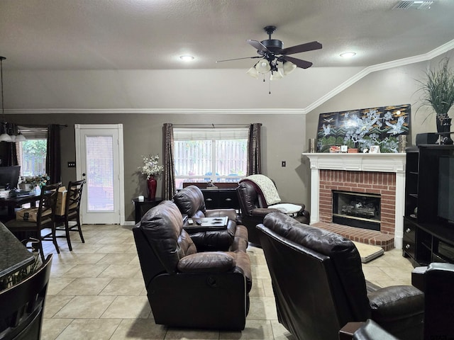 tiled living room with ornamental molding, a healthy amount of sunlight, ceiling fan, and vaulted ceiling