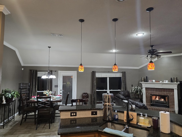 tiled living room featuring a brick fireplace, lofted ceiling, a textured ceiling, ornamental molding, and ceiling fan