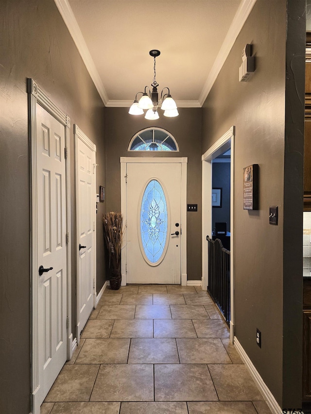 entryway with a chandelier and crown molding