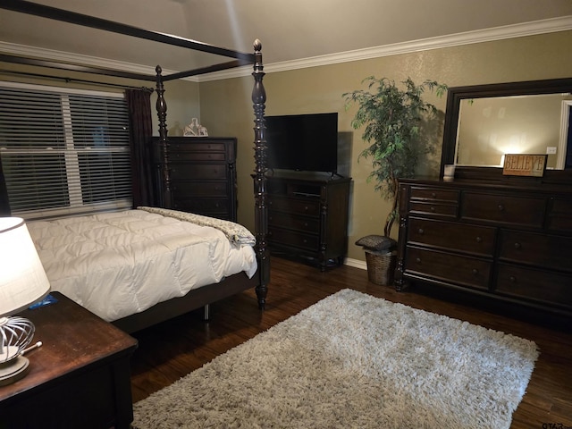 bedroom featuring ornamental molding, dark hardwood / wood-style flooring, ceiling fan, and vaulted ceiling