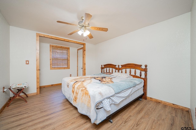 bedroom with ceiling fan and light hardwood / wood-style floors