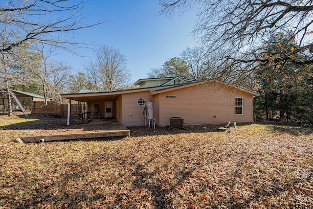 rear view of house with a carport and central air condition unit