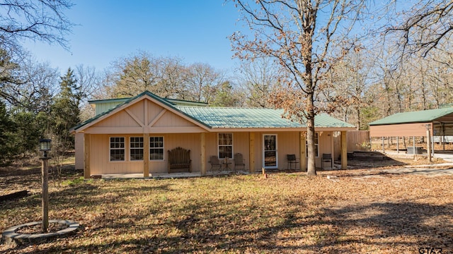 back of house with a carport