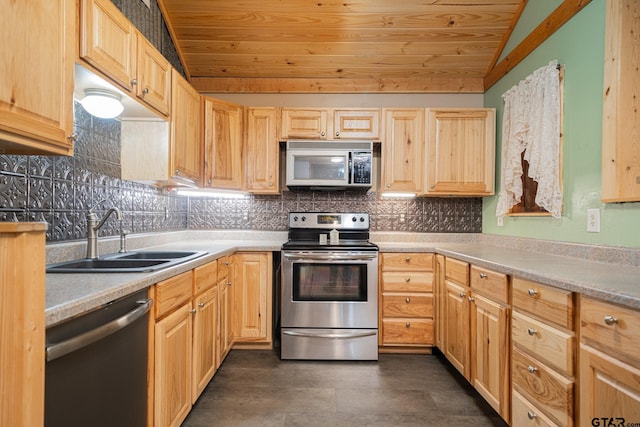 kitchen featuring light brown cabinets, lofted ceiling, sink, appliances with stainless steel finishes, and tasteful backsplash