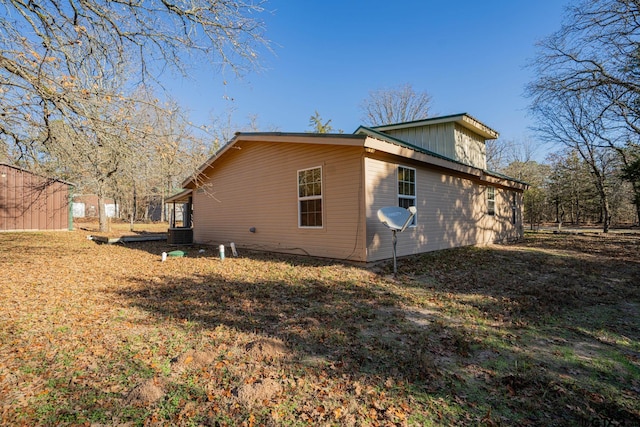 view of side of property with central air condition unit