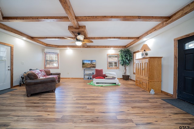 living room with beamed ceiling, ceiling fan, wood-type flooring, and an AC wall unit