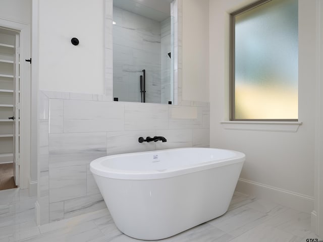 bathroom with independent shower and bath and tile walls