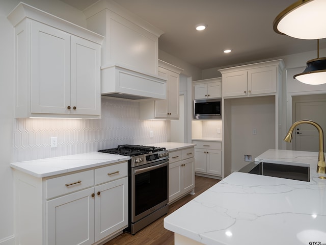 kitchen with white cabinetry, sink, and stainless steel appliances