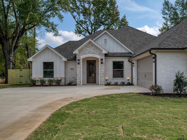 view of front of home with a front yard and a garage