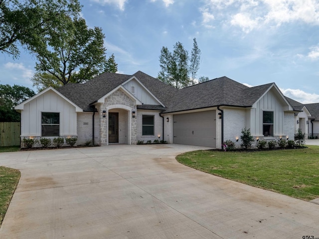 view of front of property featuring a garage and a front yard