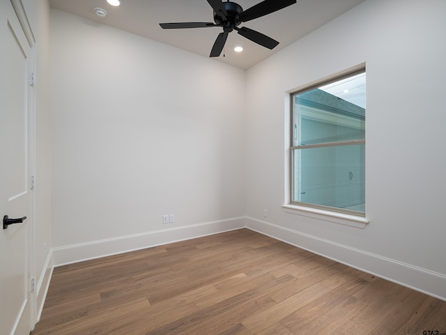 empty room featuring light wood-type flooring and ceiling fan