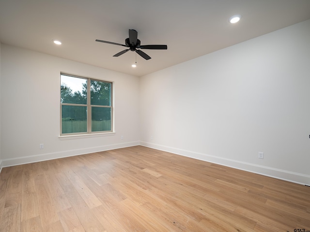 spare room featuring light hardwood / wood-style floors and ceiling fan