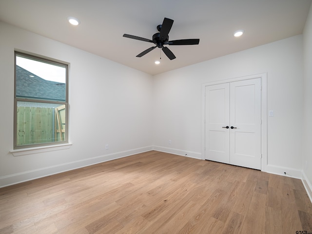 unfurnished room with ceiling fan and light hardwood / wood-style flooring