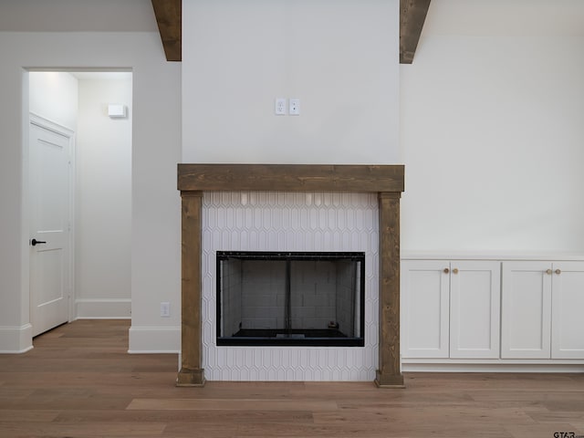 interior details with wood-type flooring and beam ceiling