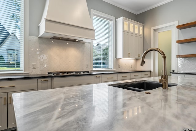 kitchen featuring white cabinets, plenty of natural light, premium range hood, and stainless steel gas cooktop